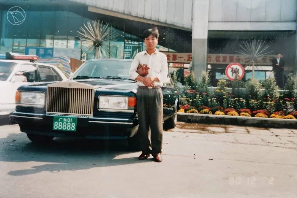 90年代初，创业期间的王军在广州白云机场外一辆劳斯莱斯轿车旁拍照留念