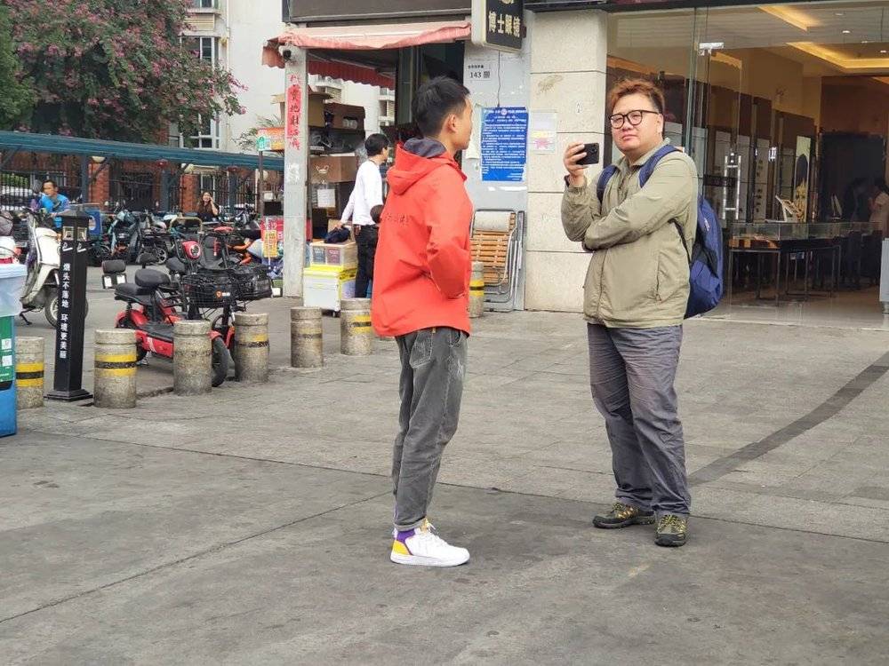 胖虎在街头采访一名健身房销售。图源：噪点<br>