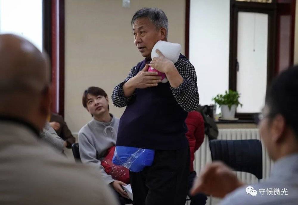 2月25日，北京一家宾馆会议室内，“男德班”课堂上，59岁的赵大爷用玩偶体验安抚哭泣的婴儿。这个板块让学员们思考生一个孩子、成为一个父亲究竟意味着什么。他是本期学员中最年长的。